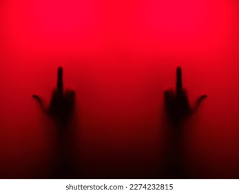 Silhouette of two hands with a sign in red light - Powered by Shutterstock