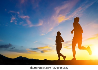 Silhouette of two person running on road go to dream. Fitness runner outdoor with sunset background. - Powered by Shutterstock