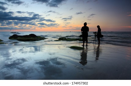 Silhouette Of Two Photographers At Sunset