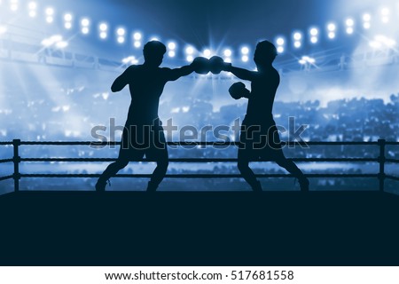 Silhouette of two professional asian boxer fight in the boxing match against stadium spotlight