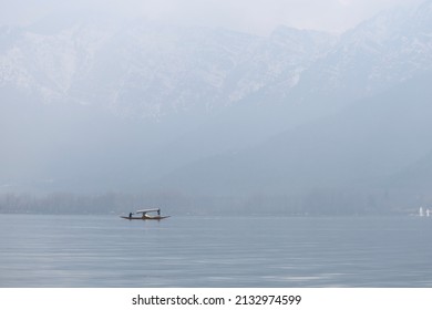 A silhouette of an unidentified man rowing a Shikara(Shikhara) boat on the Dal Lake on a winter morning at Srinagar, Jammu and Kashmir.