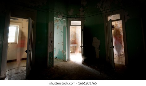 Silhouette Of An Unrecognised Person Walking Alone Through The Open Doors Of The Rooms Of An Abandoned And Creepy Hospital In Cyprus.