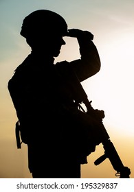 Silhouette Of US Soldier With Rifle  Against The Sunset