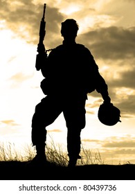 Silhouette Of US Soldier With Rifle Against A Sunset