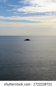 Silhouette Of Very Small Island In The Middle Of The Ocean