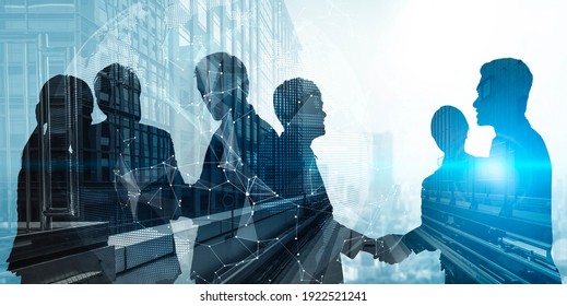 Silhouette view of business people team in group meeting on city office building background showing partnership success of business deal. Concept of teamwork, trust and agreement. - Shutterstock ID 1922521241