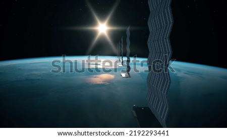 Silhouette view of a fleet of Internet starlink satellites in orbit above earth. A line of satellites providing internet connection from space with the sun in the horizon