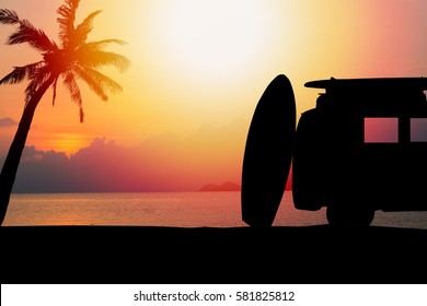 Silhouette Vintage Car In The Beach With A Surfboard On The Roof.