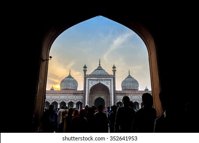 Silhouette of visitors at doorway at Jama Masjid, Old Delhi, India