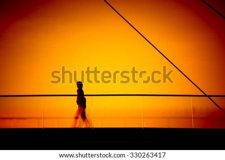 silhouette walking on the bridge at sunset