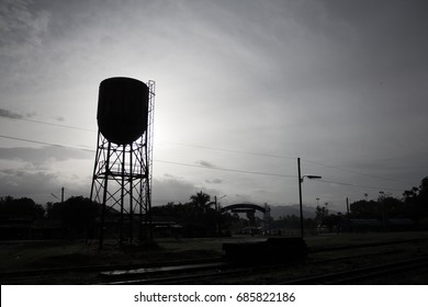 Silhouette Water Tank In The Small Town.