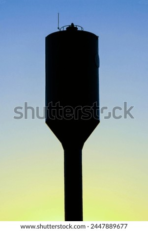 Silhouette water tank tower with soft focus