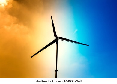 Silhouette wind turbine with half orange sky and half bright sky background, small wind turbine renewable green energy source for future - Powered by Shutterstock