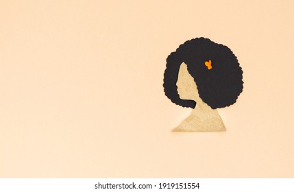 Silhouette Of Woman With Afro Hair, Cut On Paper On Cream Background. Copy Space.