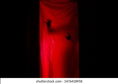 Silhouette Of A Woman Behind Red Curtains. Horror