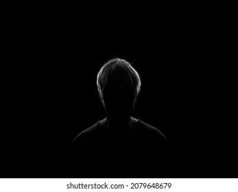 Silhouette Of A Woman In Darkness, Lit Only By Rim Light.