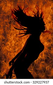 A silhouette of a woman with a fire flame background, she is flipping her hair.