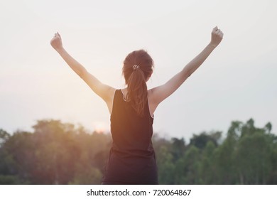 Silhouette of woman with hands raised in the sunset concept, worship.woman open arms at sunrise. - Shutterstock ID 720064867