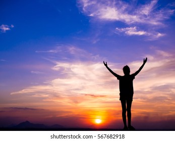 Silhouette of woman Happiest moments feeling free and show hand up  at sunset . - Shutterstock ID 567682918