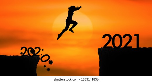 Silhouette woman jumping from 2020 cliff to 2021 cliff on sunrise time - Shutterstock ID 1853141836