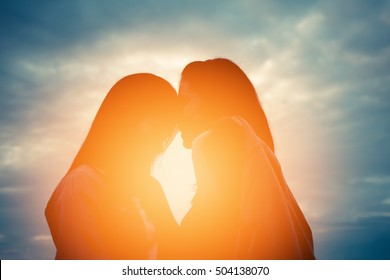 Silhouette woman lover friend at sunset - Shutterstock ID 504138070