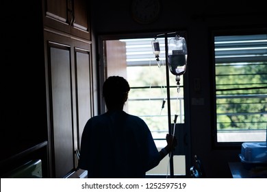 Silhouette Of A Woman Patient Waiting For Her Family In The Hospital Room.