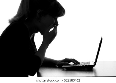 silhouette of a woman pleasantly surprised by online discounts with a laptop