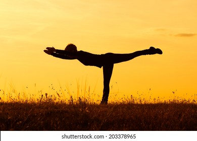 A silhouette of a woman practicing yoga,Yoga-Virabhadrasana III /Warrior Pose III