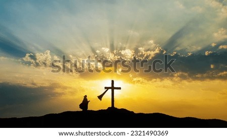 Silhouette of a woman praying at Holy Cross. Jesus Christ is alive.