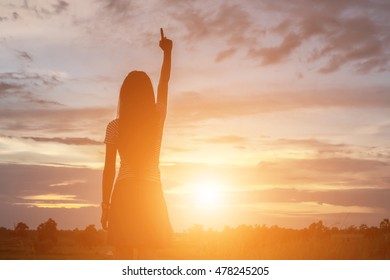Silhouette of woman praying over beautiful sky background - Shutterstock ID 478245205