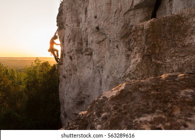 A Silhouette Of A Woman Rock Climbing On Ontario's Niagara Escarpment In Canada