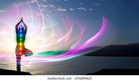 Silhouette of woman sits in a otus pose on beach sunset view, glowing seven all chakra. Kundalini energy. girl practicing yoga meditation outdoors