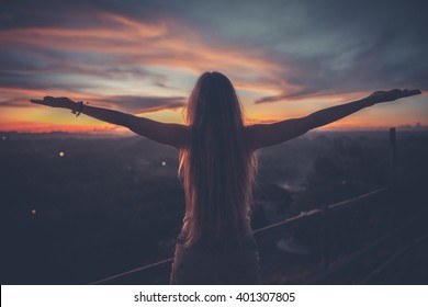 Silhouette Of The Woman Spreading Arms And Standing High On The Viewpoint With Breathtaking View Over Fields In Sunset Light.Chocolate Hills, Bohol Island, Philippines.