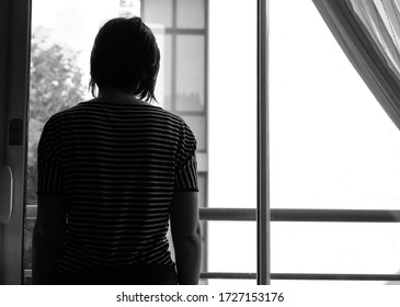 Silhouette of a woman trapped at home with violent man during the great lock down. Sign of domestic violence