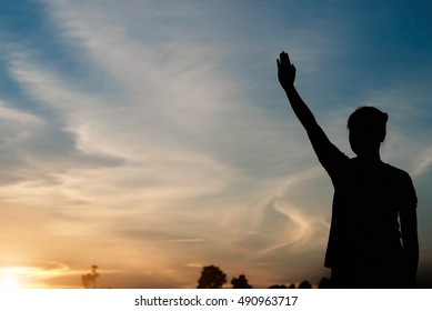 silhouette of woman two hands on the sky at sunset. - Shutterstock ID 490963717