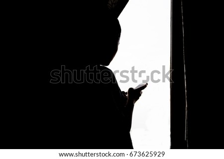 Silhouette woman using smartphone 