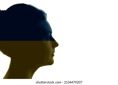 Silhouette of a woman's face filled with colors of the Ukrainian flag, concept of the Russian-Ukrainian war. - Powered by Shutterstock