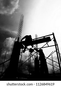 Silhouette Worker, Construction Crews Work On High Ground Heavy Industry Over Blurred Natural Background Sunset