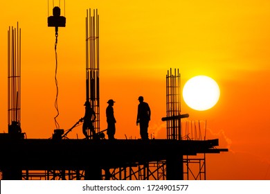 Silhouette Worker Construction site with Orange Sunset Sky background in the evening 