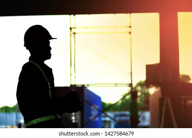 Silhouette Worker At Warehouse Construction Site.