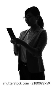 Silhouette Of Young Asian Woman Using A Smart Phone.