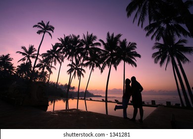 Silhouette of young couple kissing at sunrise - Powered by Shutterstock