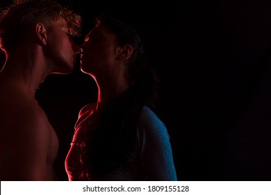 silhouette of a young couple. Couple in love. Sensual. Dark background. Hot photo. 