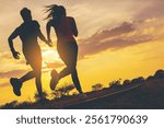 Silhouette of young couple running together on road across the bridge. Couple, fit runners fitness runners during outdoor workout	