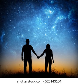  Silhouette of young couple under stars. The concept on the theme of love. Elements of this image furnished by NASA.