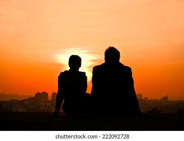 Silhouette of  young couple watching sunset 