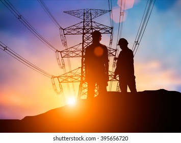 Silhouette The Young Engineer Was Thinking To Comply With Environmental, Construction And The Environment Around Us And Have A Minimal Impact On The Public Over Blurred High Voltage Transmission Lines