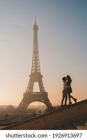 Silhouette of young european couple kisses near the Eiffel tower