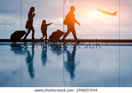 Silhouette of young family and airplane