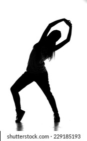 Silhouette of young hip-hop dancer woman is showing some moves on the white background.